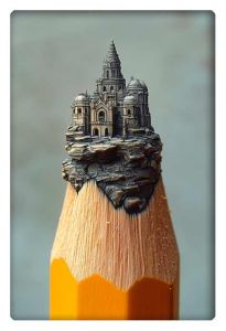 A highly detailed miniature civilization built on the sharpened tip of a pencil. The structure resembles a grand castle or temple with domes and spires, intricately carved into the wood, standing precariously on the narrow tip.