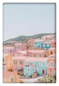 A light and airy photograph of pastel-colored houses in pink, blue, and yellow, nestled on a hillside against a backdrop of lush green hills under a soft sky.