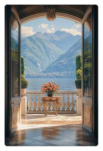 Elegant open doors revealing a picturesque view of a lake surrounded by mountains, with a small table of flowers on a sunlit balcony